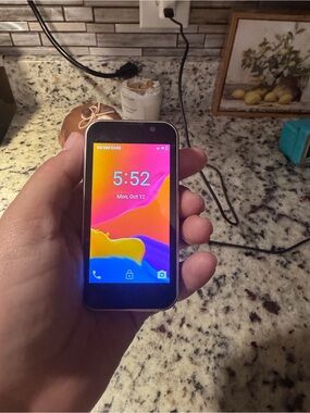 Source Unknown Black Compact Smartphone with Color Display